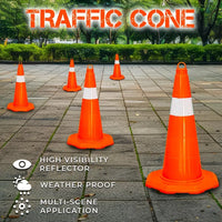 Orange traffic cones with reflective stripes on a paved surface.