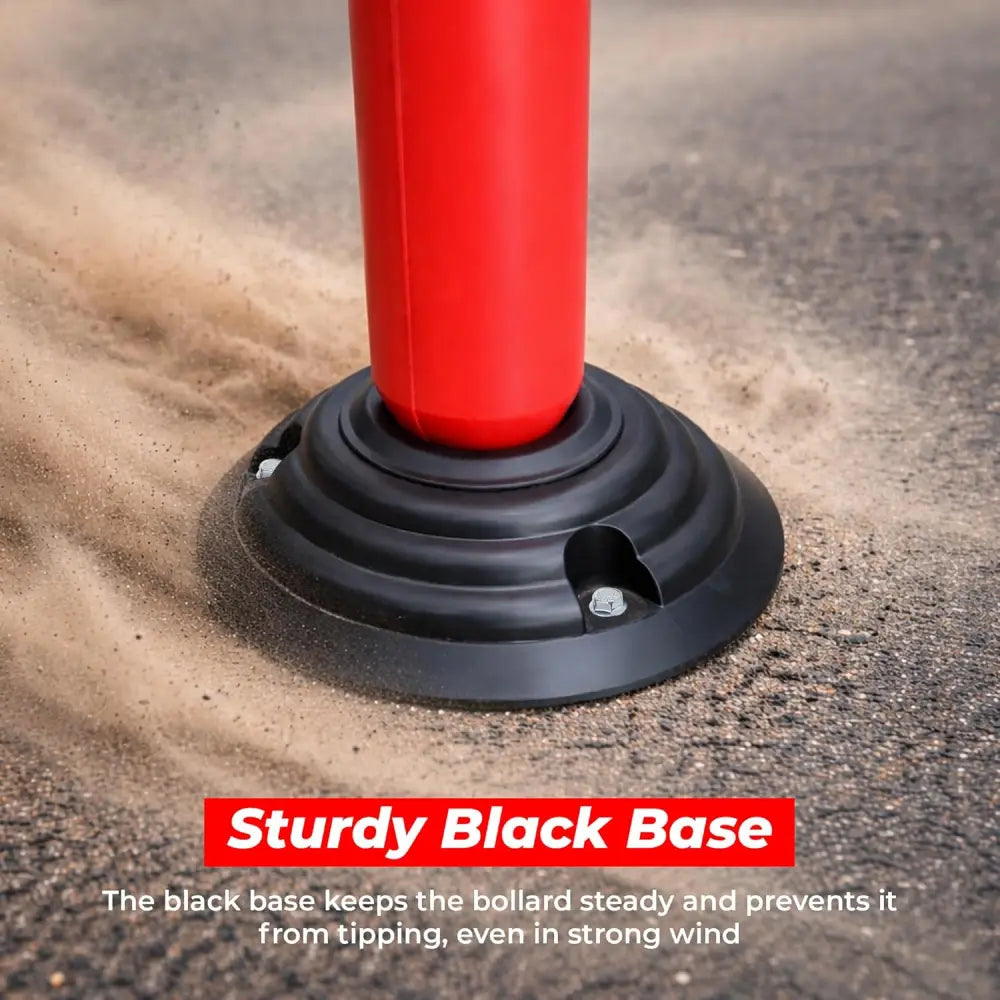 Red bollard with a black base on a textured surface
