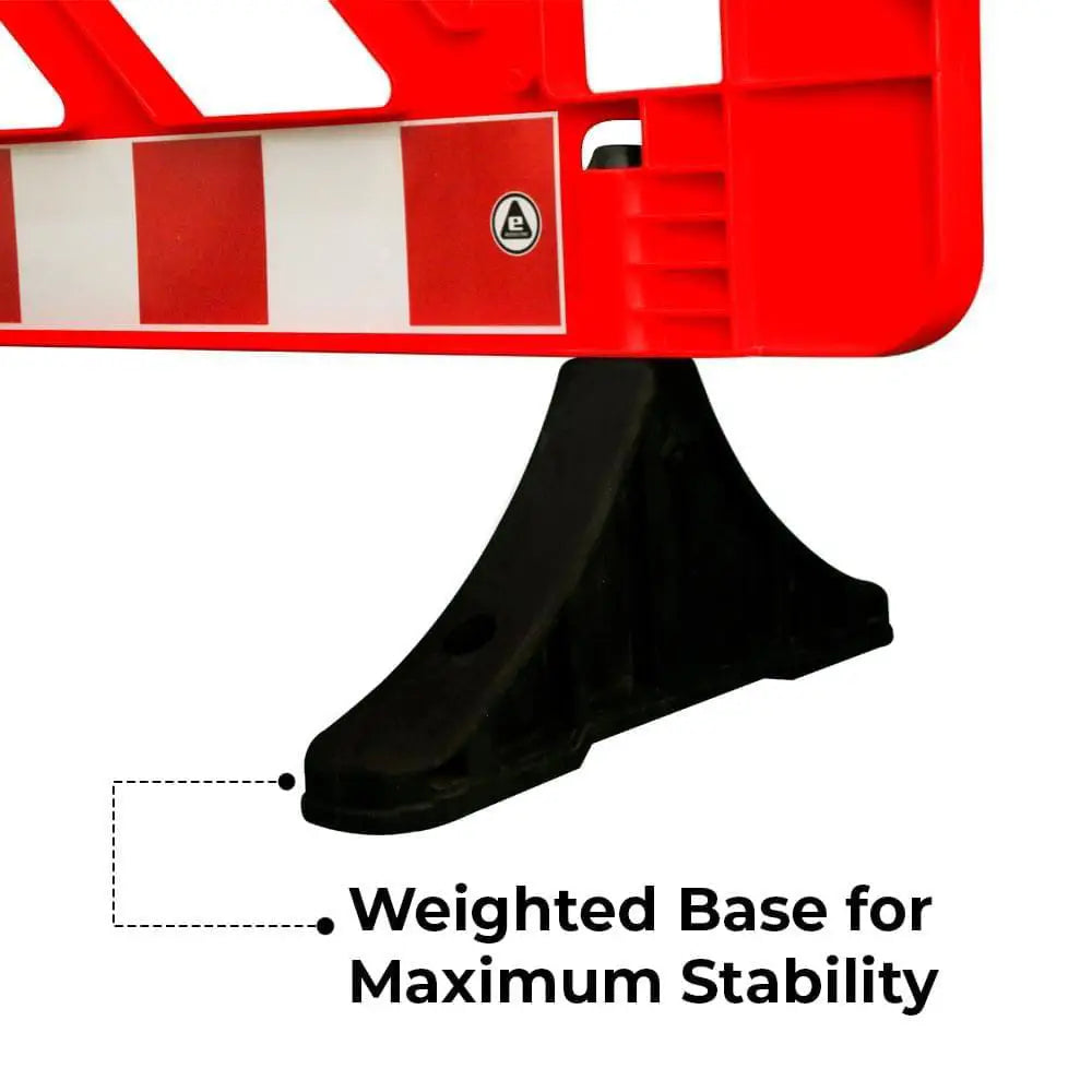 Red and white barrier with a black weighted base