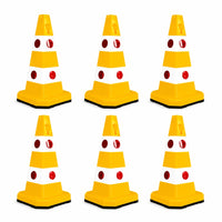 Six yellow and white traffic safety cones