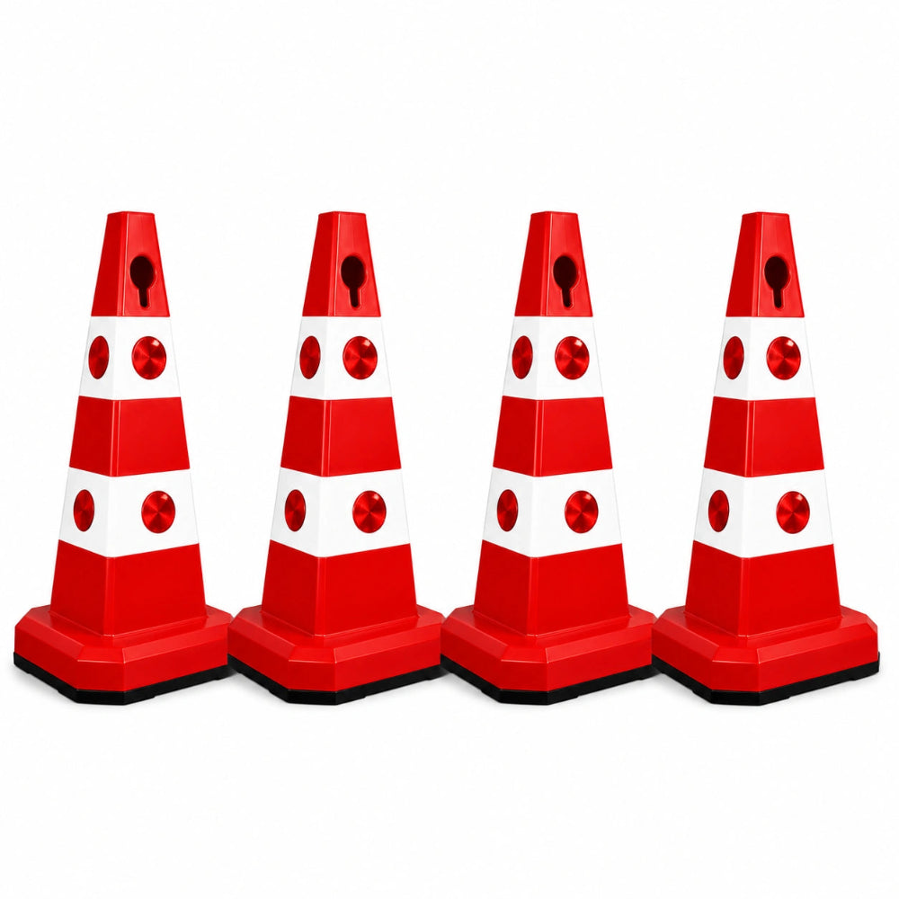 Four red and white plastic traffic safety cones