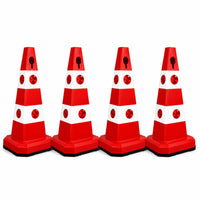 Four red and white plastic traffic safety cones