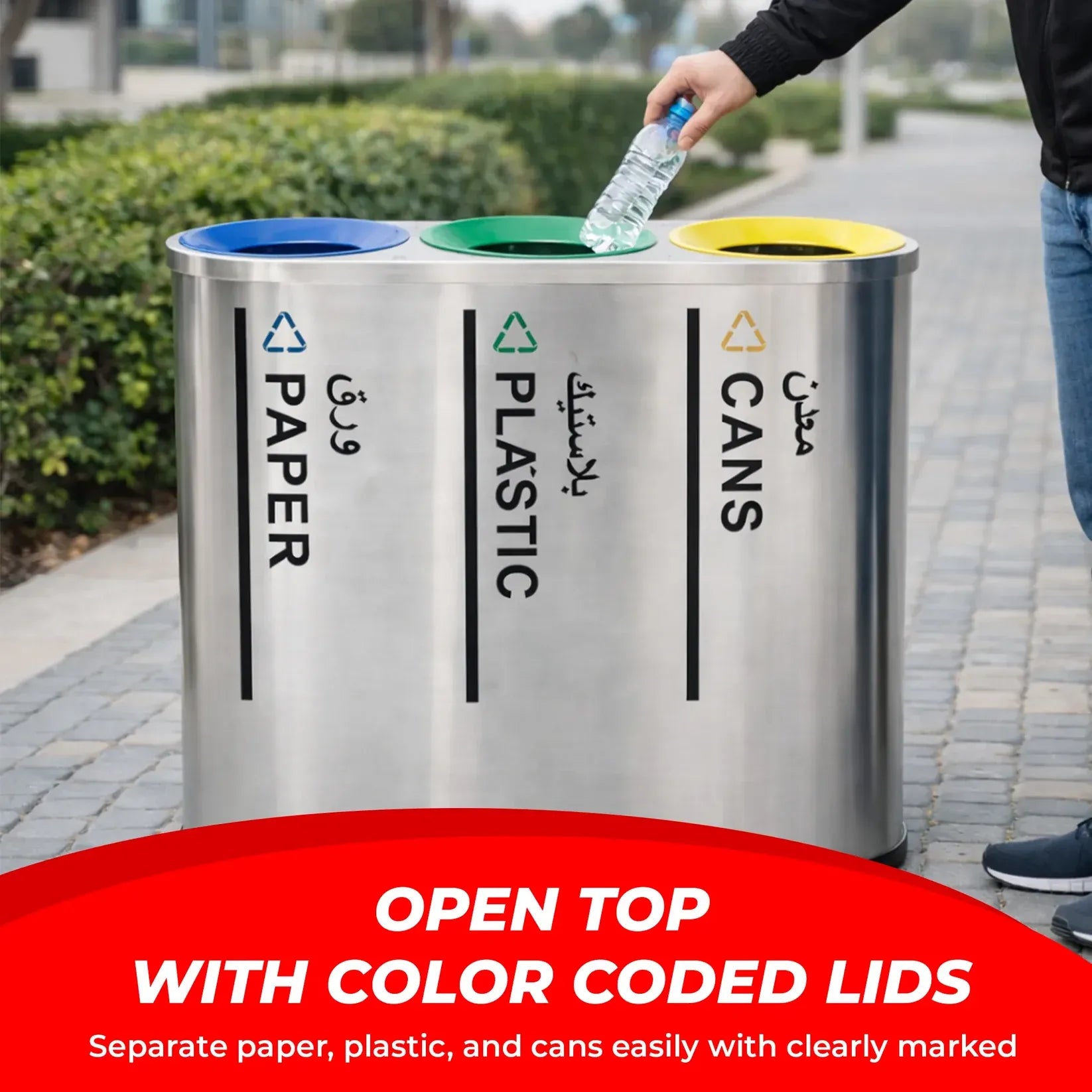 Recycling bin with color-coded lids for paper, plastic, and cans on a sidewalk.