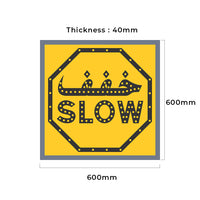 Yellow sign with 'SLOW' text and measurements on a white background