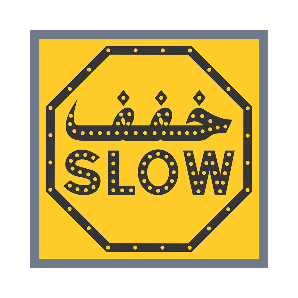 Yellow sign with black border and 'SLOW' text on a white background