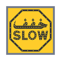 Yellow sign with black border and 'SLOW' text on a white background