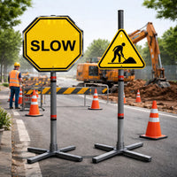 Roadwork scene with 'SLOW' and construction worker signs, traffic cones, and excavator.