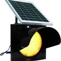 Solar-powered traffic light with a yellow warning light on a white background