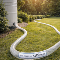 White garden hose with 'PIRI Industries Mermaid' branding on grass next to a water tank.