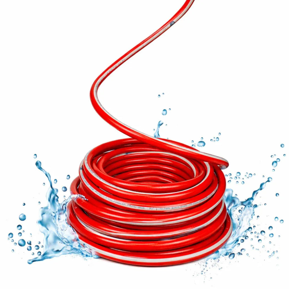 Red garden hose with water splashes on a white background