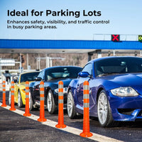 Orange traffic cones on a parking lot with cars, enhancing safety and visibility.