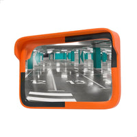Orange safety mirror showing a parking garage