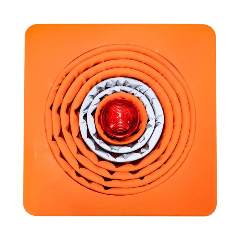 Stack of orange mats with a red light in the center 