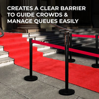 Red carpet with black stanchions guiding crowds,