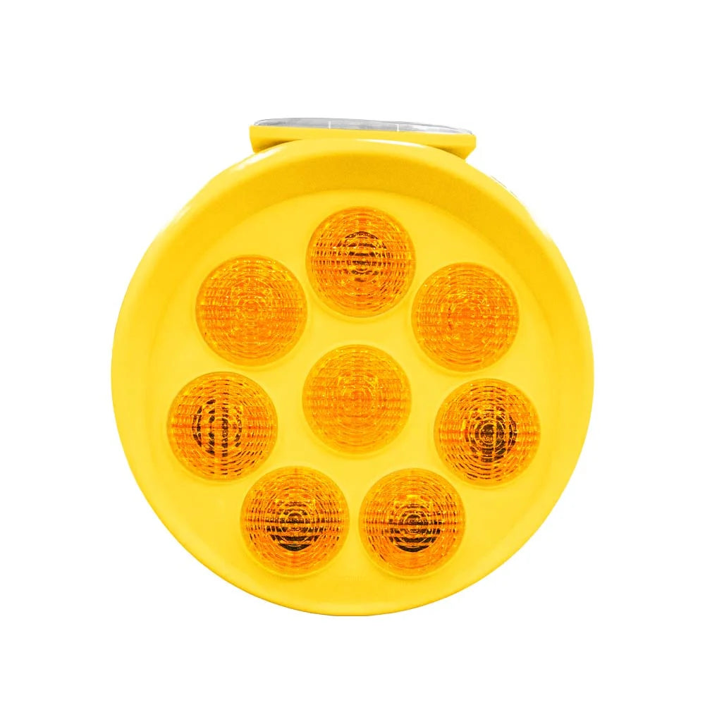 Yellow round reflective safety light with multiple lenses on a white background
