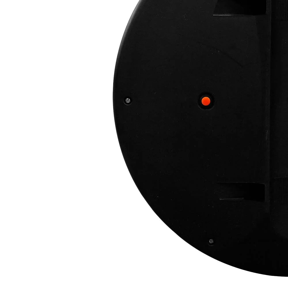 Close-up of a black clock mechanism with an orange dot on a white background