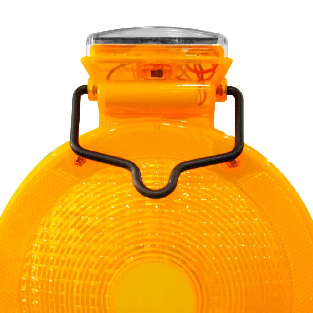 Close-up of a yellow safety light with a black handle on a white background