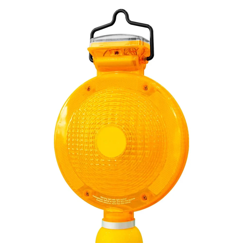 Yellow safety light with black handle on a white background
