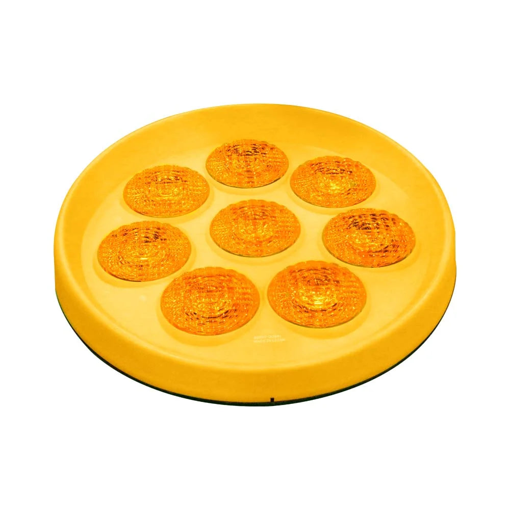 Yellow round object with multiple circular indentations on a white background