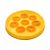 Yellow round object with multiple circular indentations on a white background