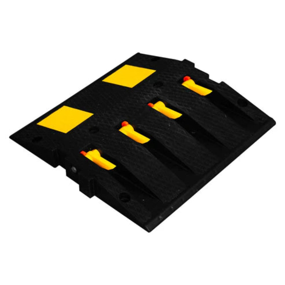 Black rubber speed bump with yellow spikes on a white background